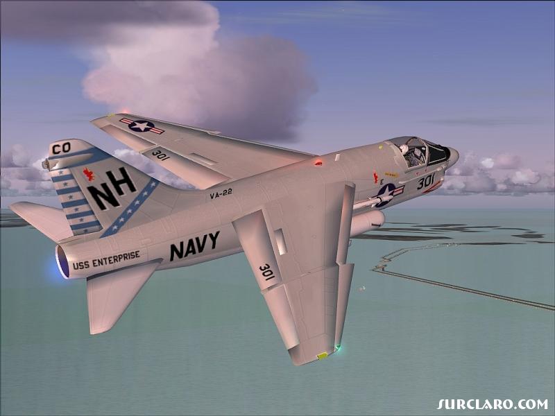 An old classic Navy fighter bird.  Vought A-7E on a climbout after a late PM takeoff with a backdrop of the Chesapeake Bay (VA USA).  That's the famous bay bridge down below. - Photo 5849